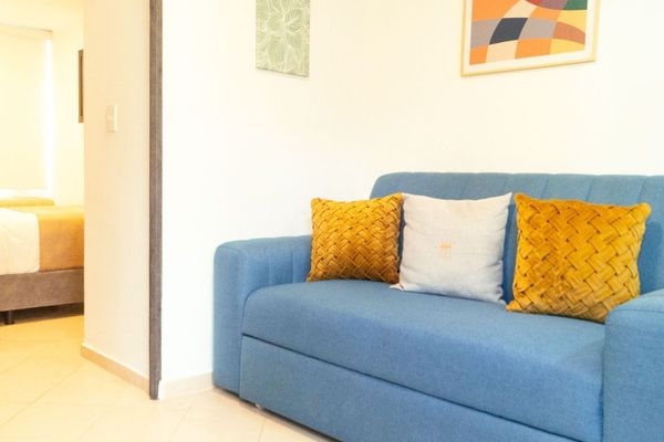 En el centro de este acogedor apartamento encontrarás un sofá que no solo invita a la relajación sino que se transforma en un sofá cama cuando la ocasión lo requiere, dejando que el estrés del día se desvanezca y tu descanso sea como ningún otro.
